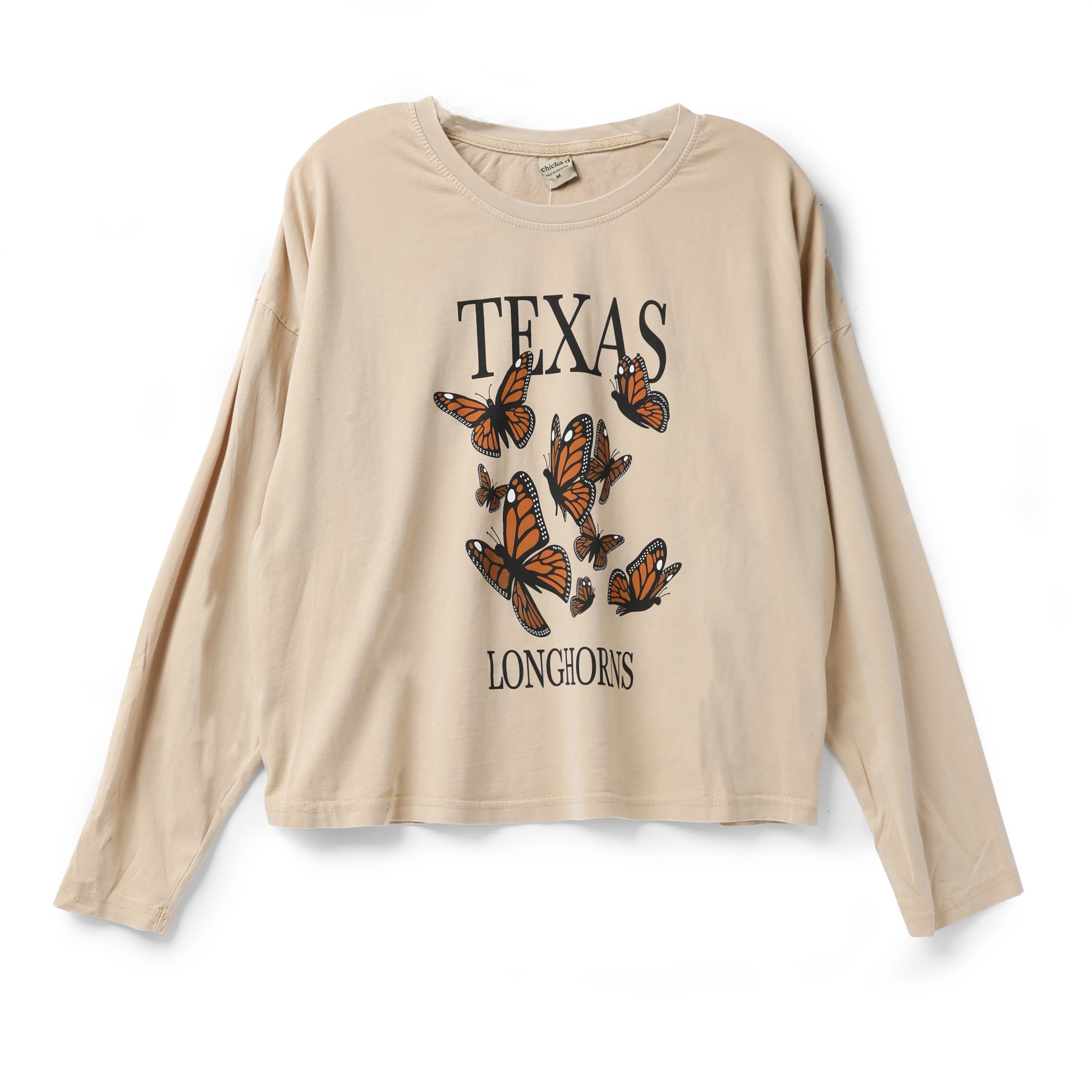 A beige long-sleeve t-shirt with a 'TEXAS LONGHORNS' graphic featuring orange and black monarch butterflies, displayed flat against a white background.
