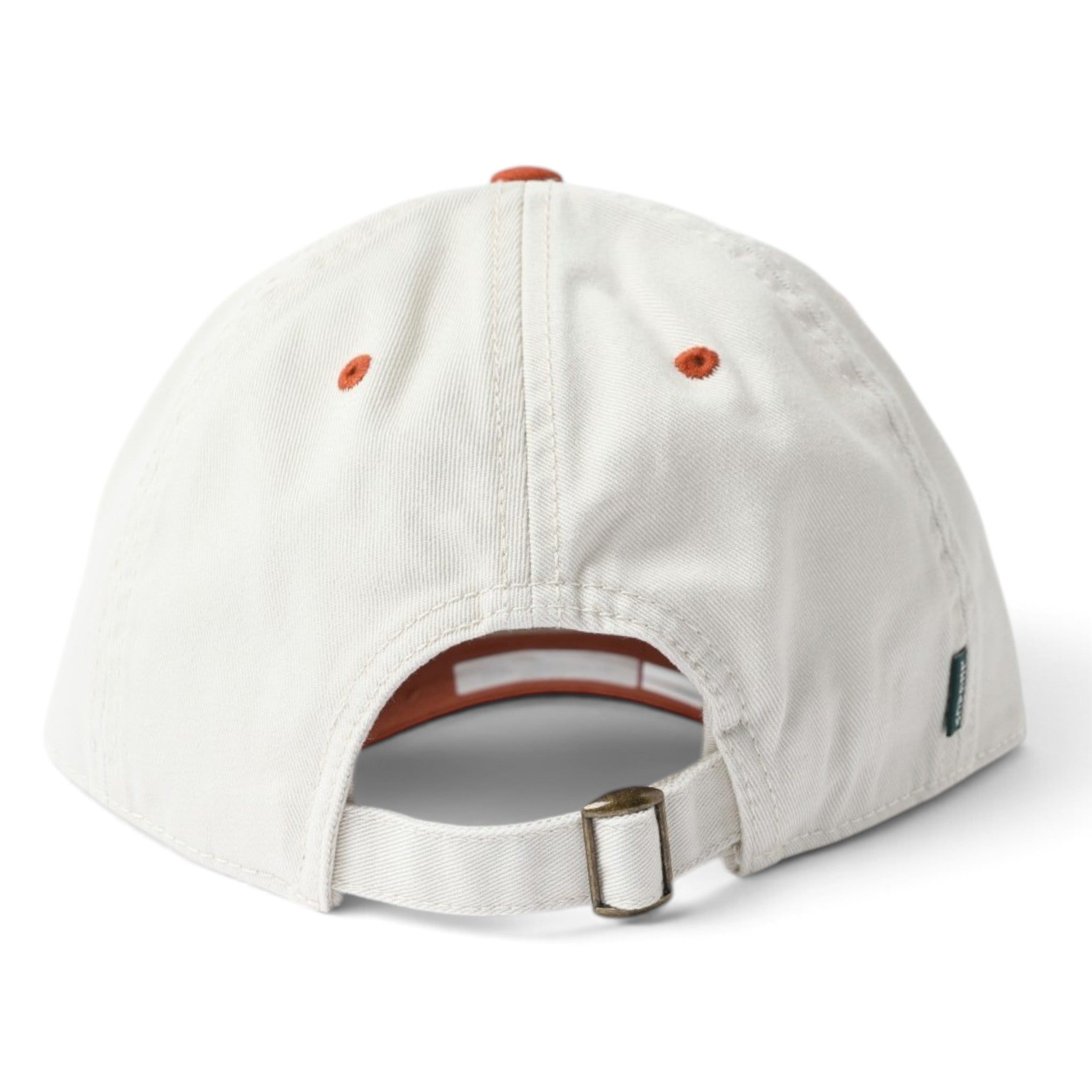 The back view of a light beige baseball cap with orange eyelets and a brown adjustable strap with a metal buckle.