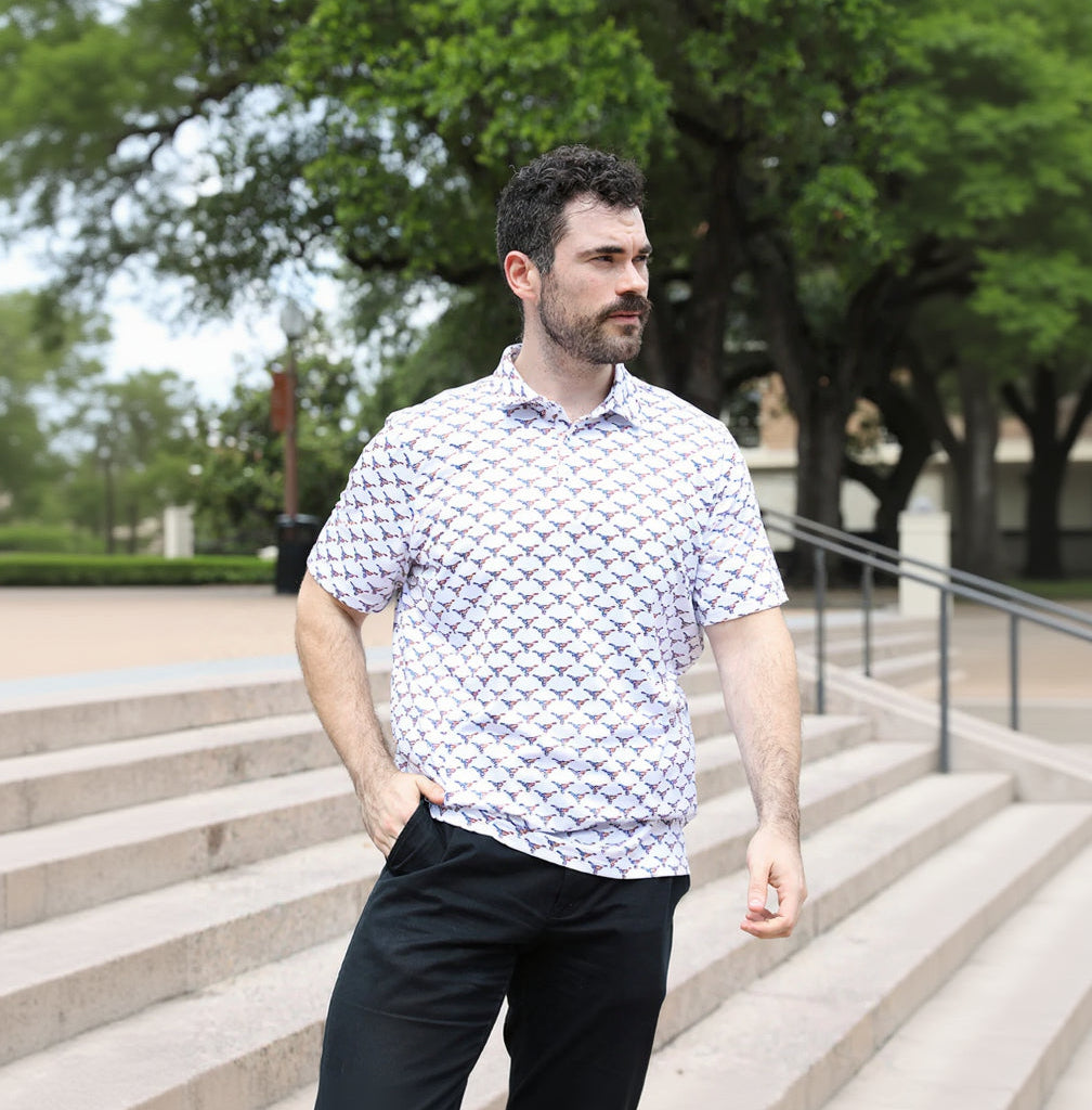 Longhorn fan wearing a patterned shirt standing outdoors with trees in the background
