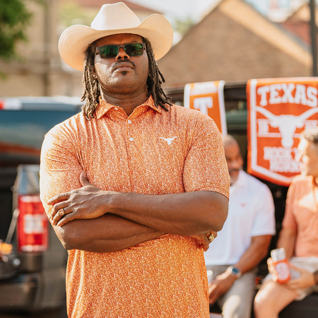 Man wearing burnt orange Texas Longhorn tailgate polo with cowboy hat