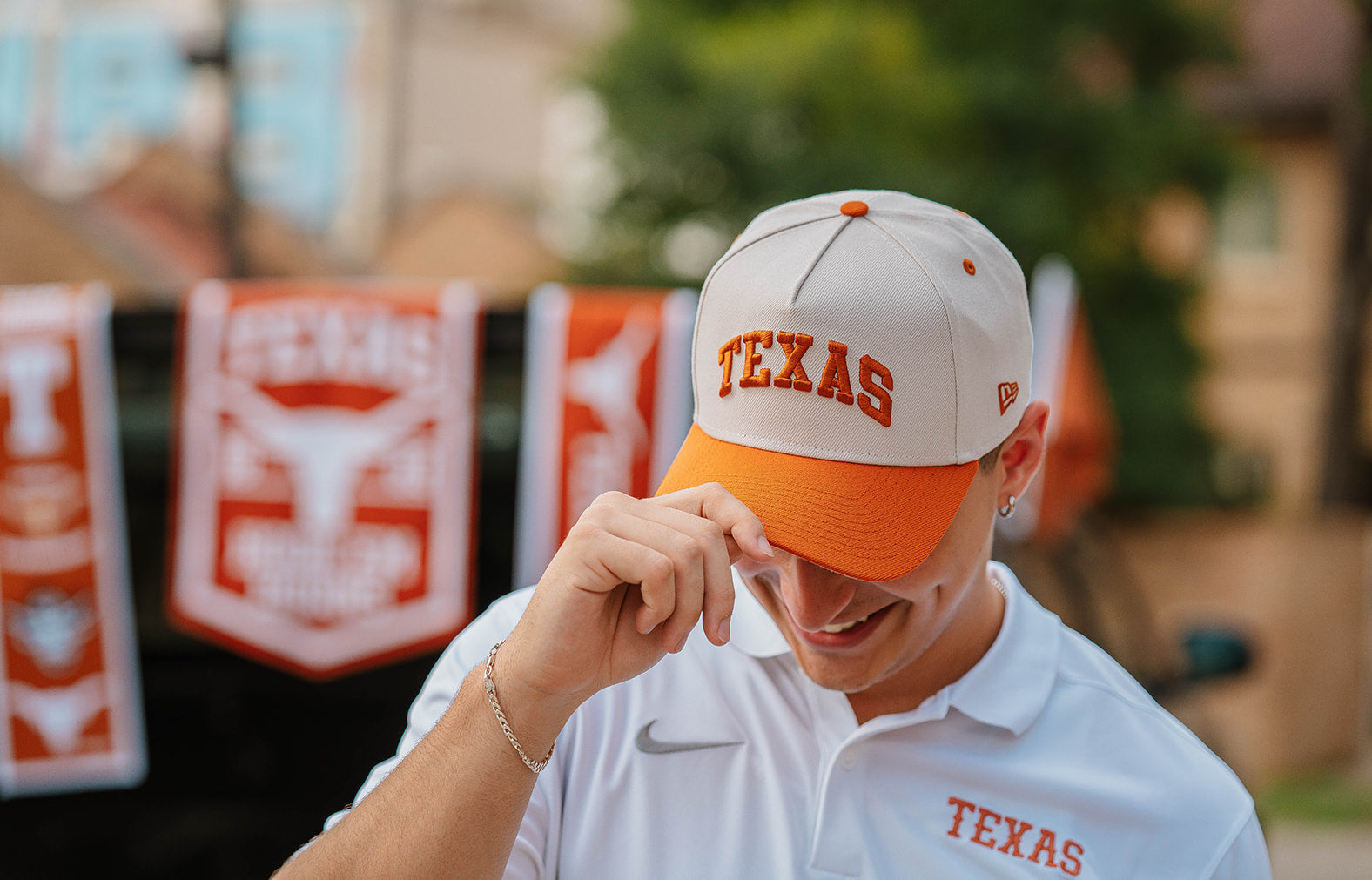 Longhorn wearing a 'TEXAS' cap at a tailgate