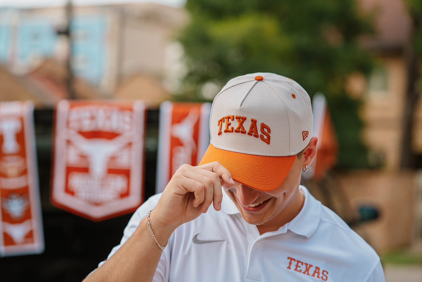 Longhorn wearing a Texas cap at a tailgate