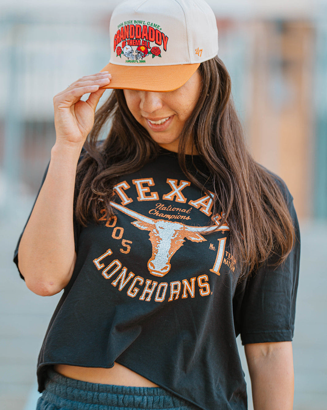 Person wearing a Texas Longhorns t-shirt and a cap with a blurred background